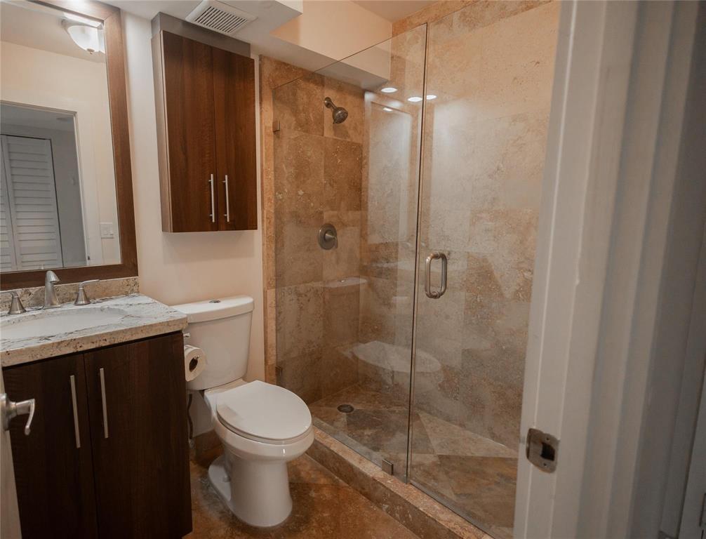 4152 Inverrary Drive, Unit 202 Lauderhill, FL 33319 - Photo 9 of 13 a bathroom with a shower toilet and sink