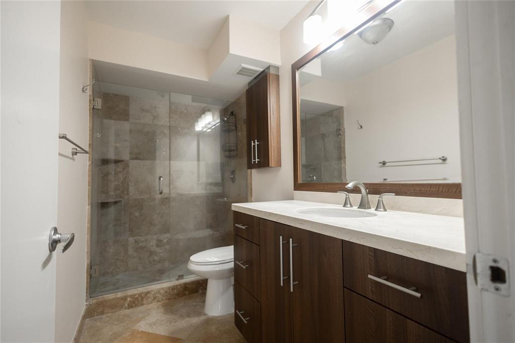 4152 Inverrary Drive, Unit 202 Lauderhill, FL 33319 - Photo 10 of 13 a bathroom with a sink a toilet and shower