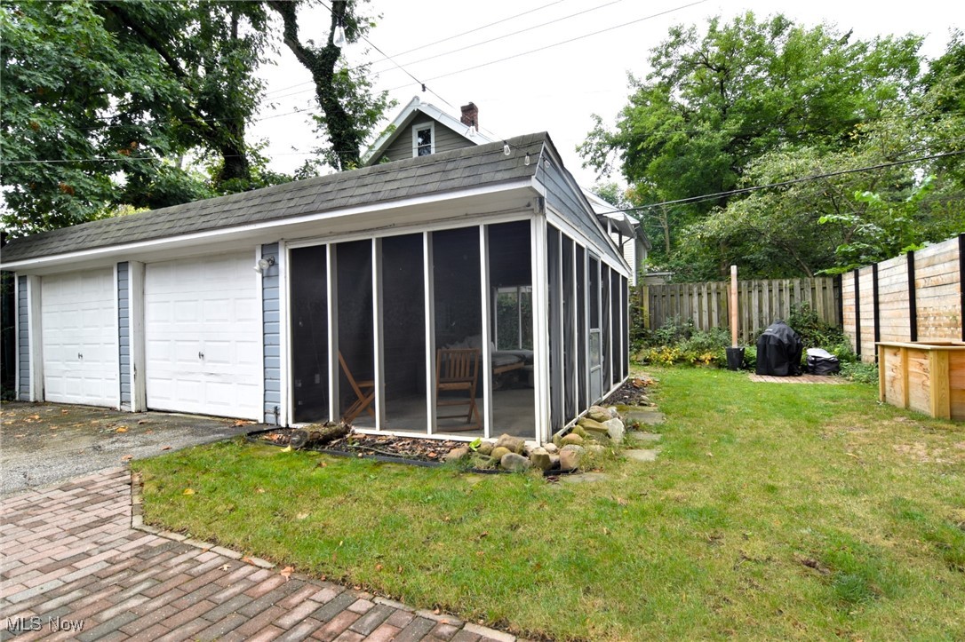 13048 Cedar Road Cleveland, OH 44118 - Photo 34 of 40 Garage featuring a lawn