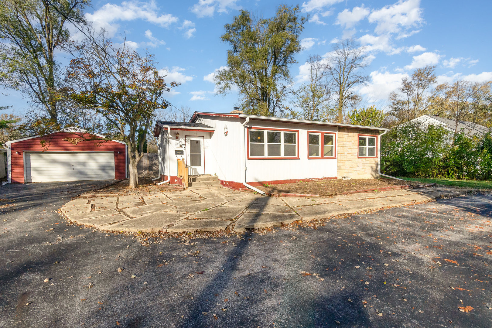 a view of a house with a backyard and a tree