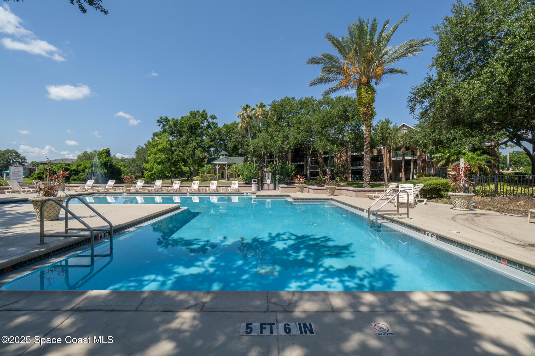 7667 North Wickham Road, Unit 222 Melbourne, FL 32940 - Photo 13 of 38 a swimming pool with outdoor seating and yard