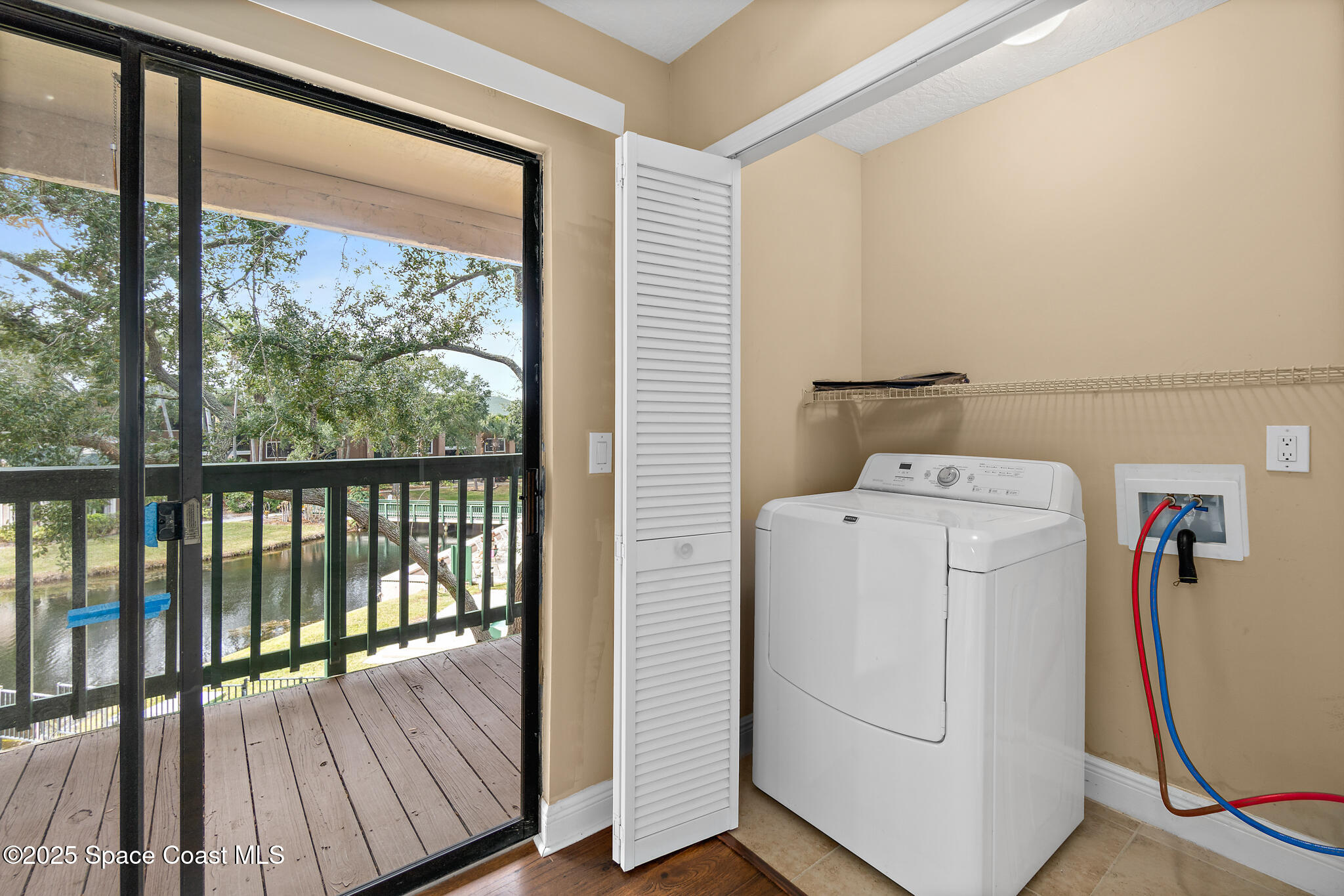 7667 North Wickham Road, Unit 222 Melbourne, FL 32940 - Photo 21 of 38 a utility room with dryer and washer