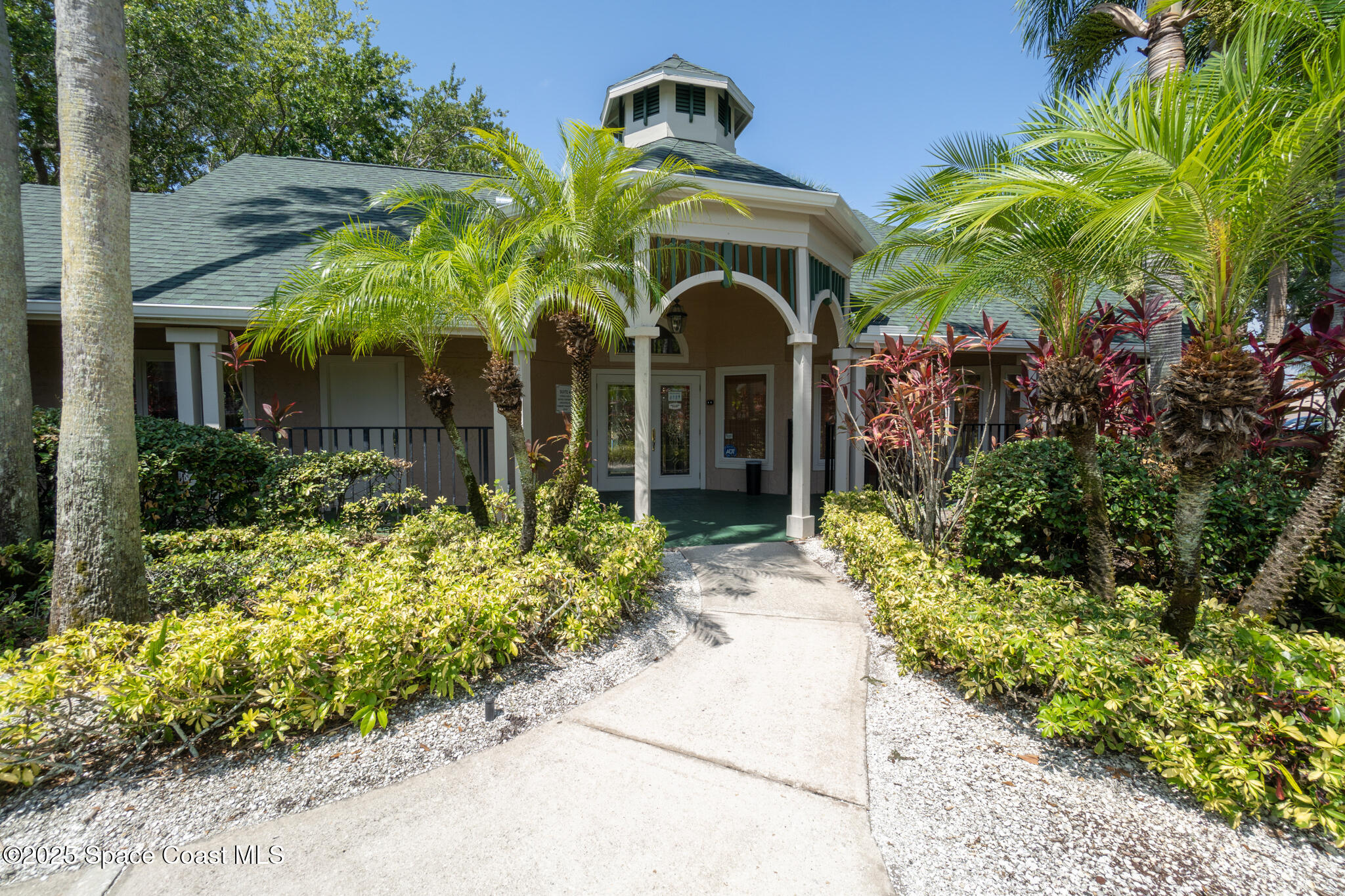 7667 North Wickham Road, Unit 222 Melbourne, FL 32940 - Photo 35 of 38 a front view of a house with a yard
