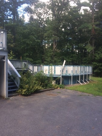 121 Townsend Road Shirley, MA 01464 - Photo 25 of 29 a view of house next to a yard with potted plants and large trees