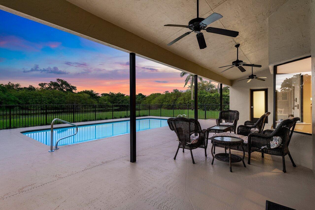 11842 Island Lakes Lane Boca Raton, FL 33498 - Photo 5 of 49 a view of a patio with a table chairs and a backyard