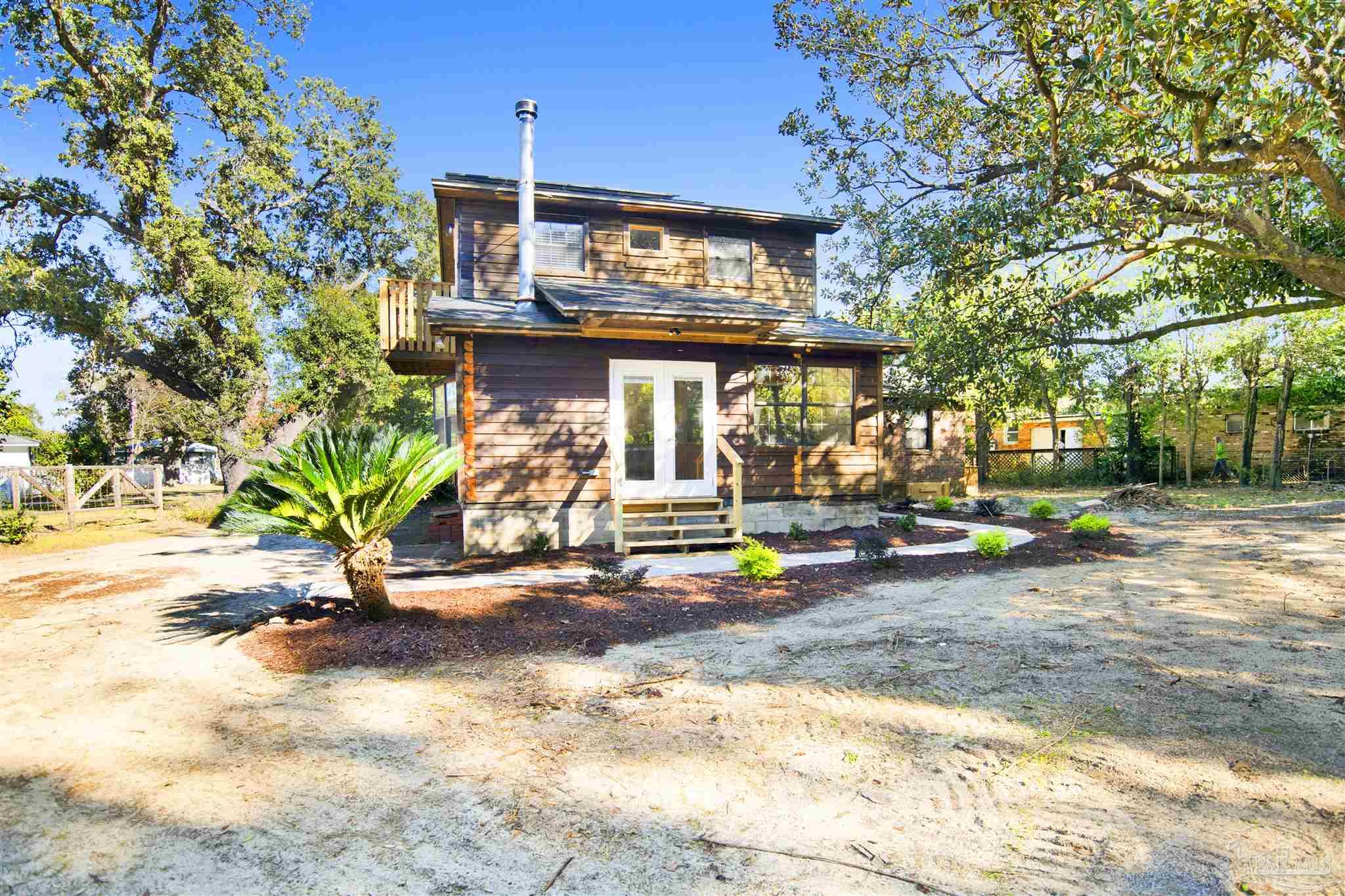 a view of a chairs and table in the backyard
