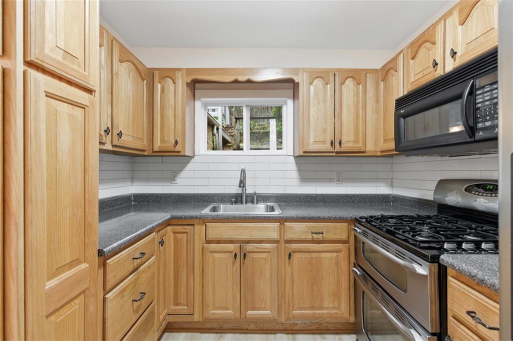 13 Marchmont Street Pittsburgh, PA 15205 - Photo 11 of 29 a kitchen with granite countertop cabinets stainless steel appliances a sink and a window