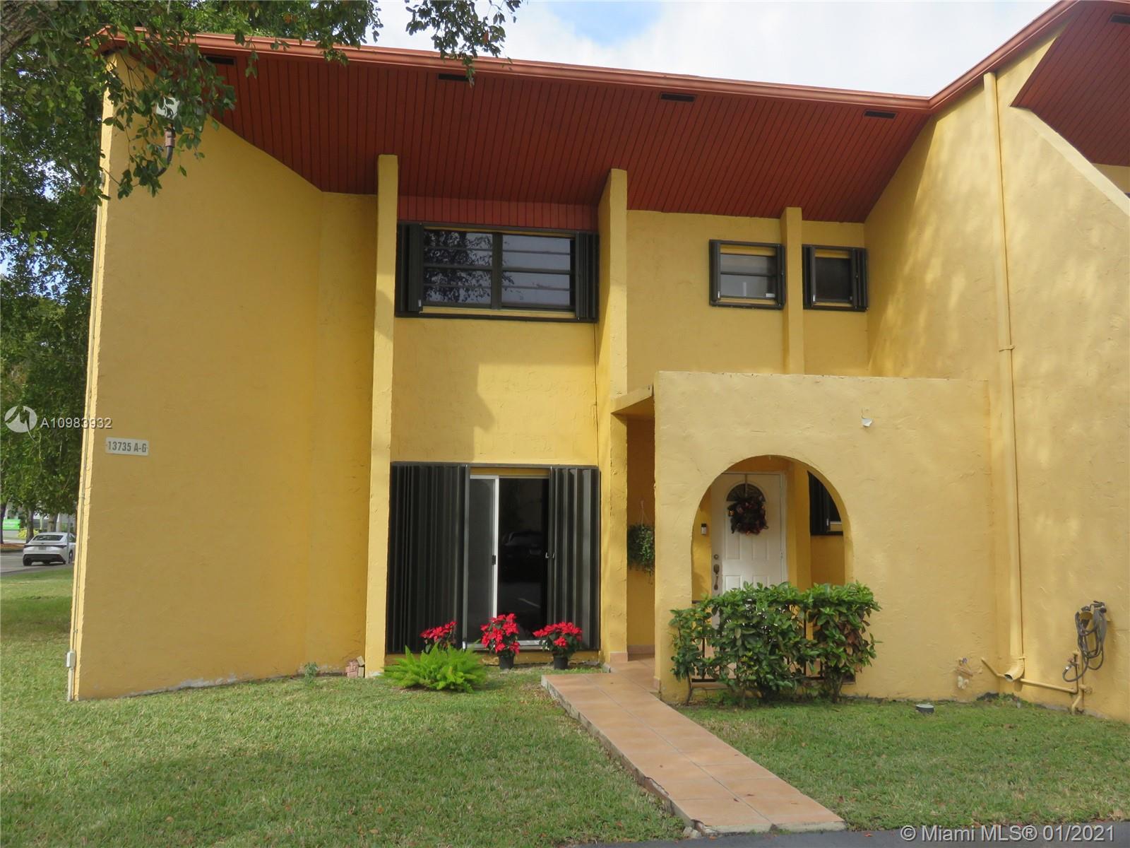 13735 Southwest 84th Street, Unit A Miami, FL 33183 - Photo 1 of 19 a front view of a house with garden