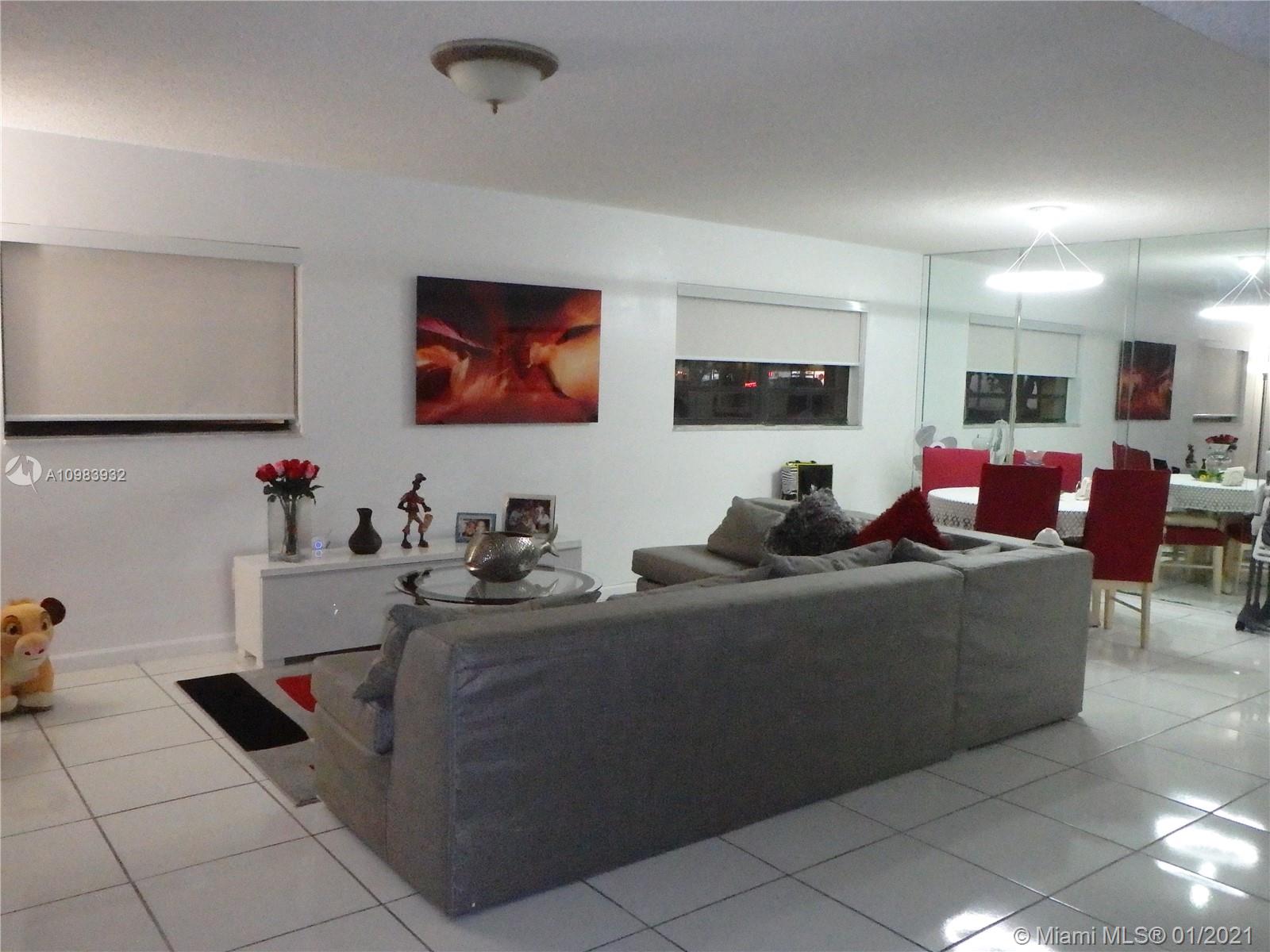 13735 Southwest 84th Street, Unit A Miami, FL 33183 - Photo 2 of 19 a living room with furniture and a flat screen tv