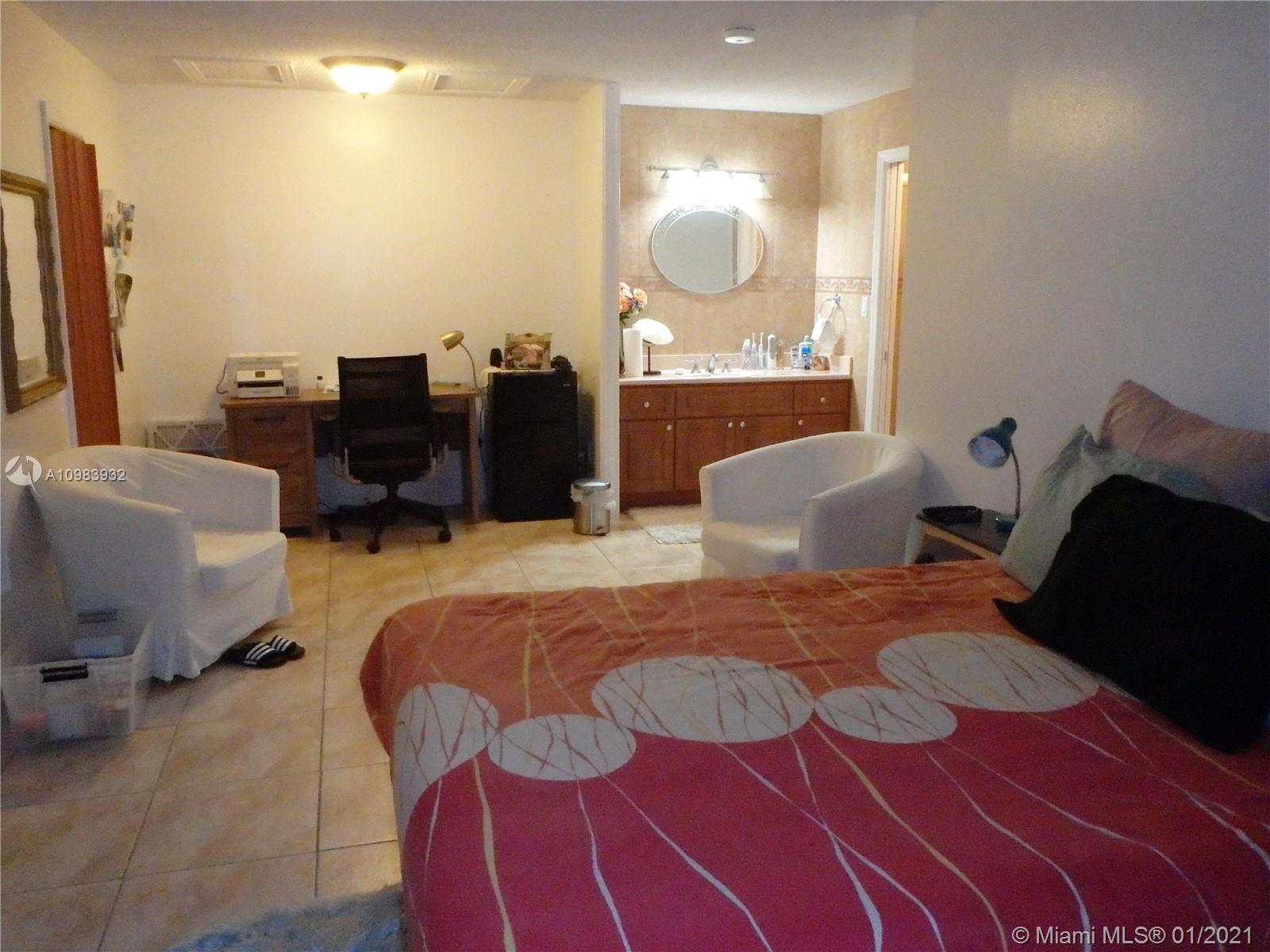 13735 Southwest 84th Street, Unit A Miami, FL 33183 - Photo 11 of 19 a bed room with a bed and dresser