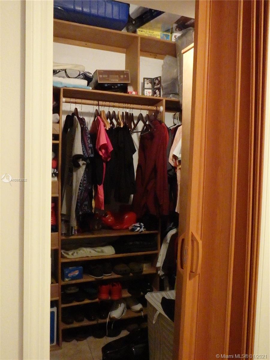 13735 Southwest 84th Street, Unit A Miami, FL 33183 - Photo 15 of 19 a view of walk in closet with clothes and shoes