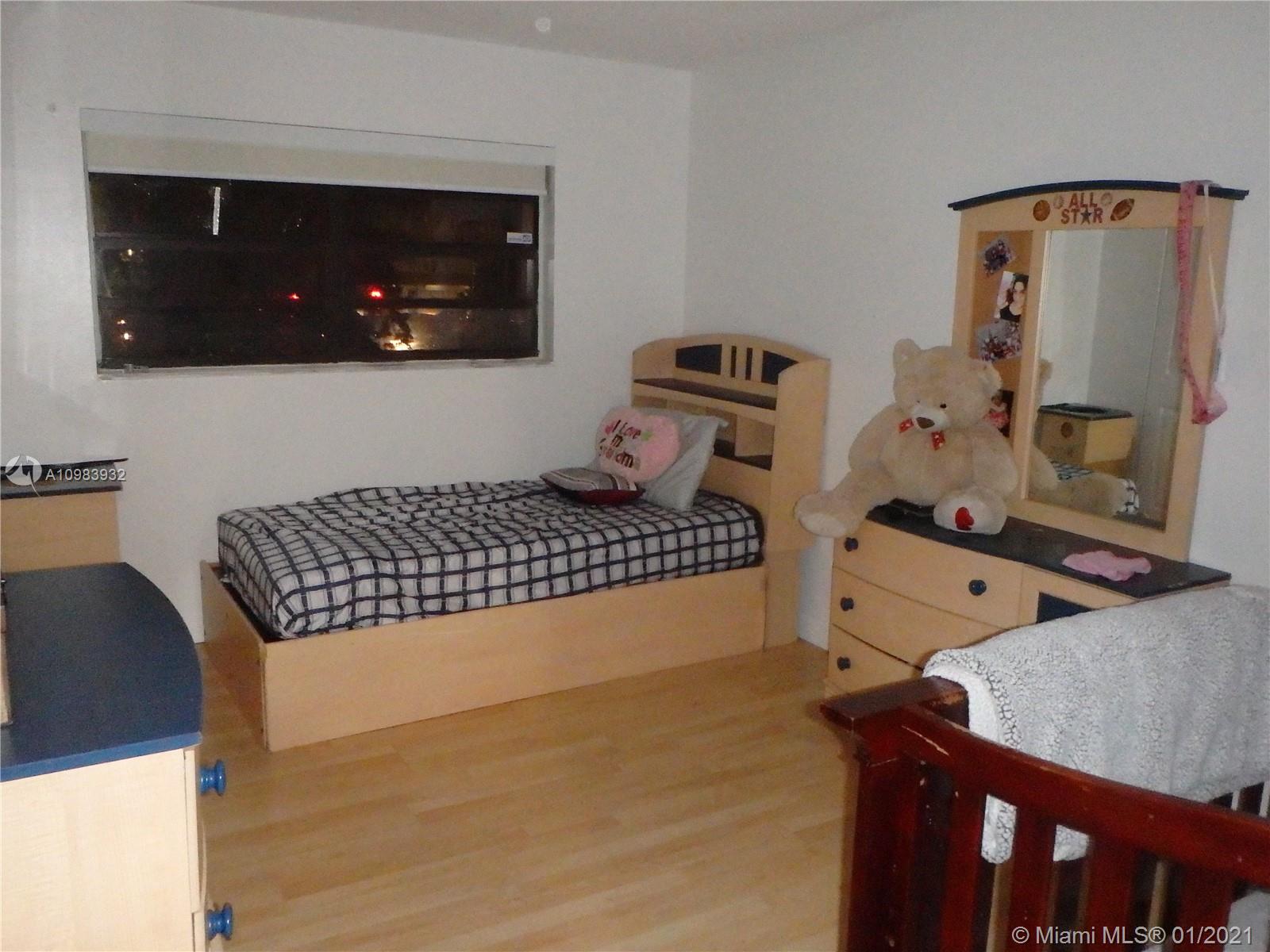 13735 Southwest 84th Street, Unit A Miami, FL 33183 - Photo 17 of 19 a living room with chairs and a flat screen tv