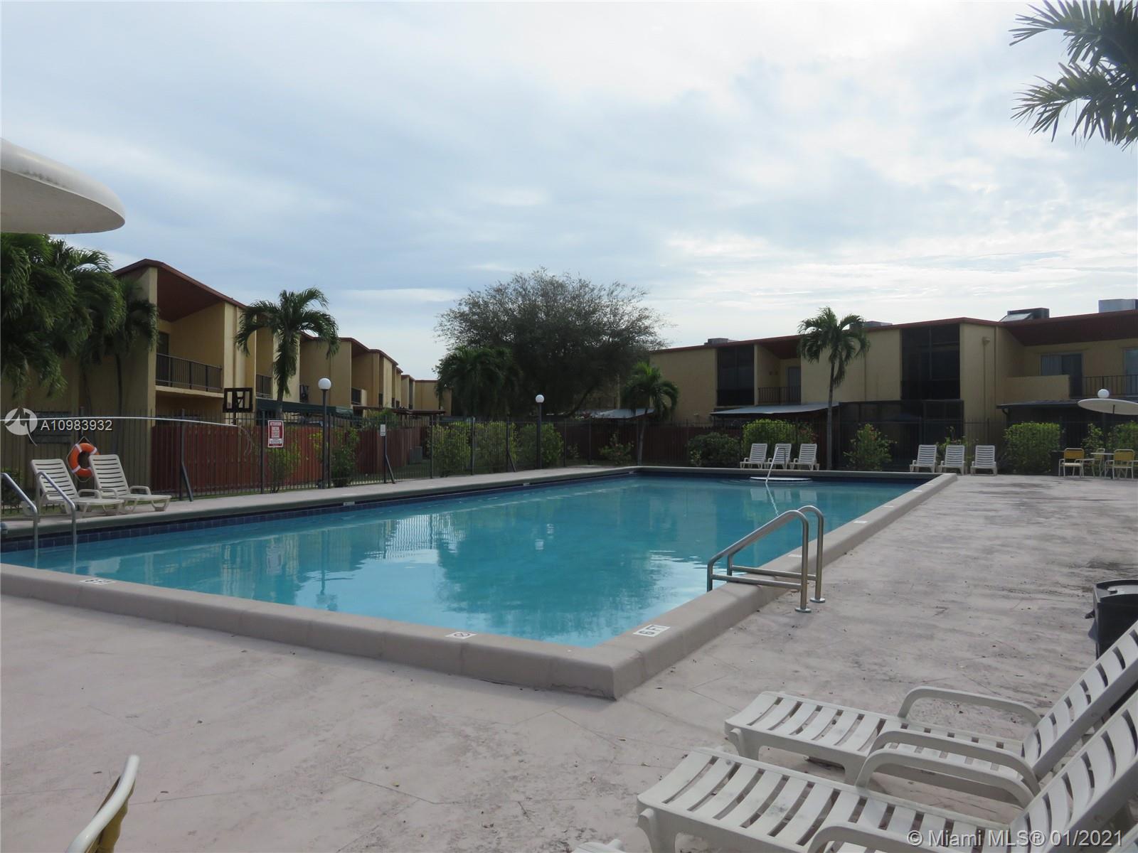 13735 Southwest 84th Street, Unit A Miami, FL 33183 - Photo 19 of 19 a view of a swimming pool with a lounge chair