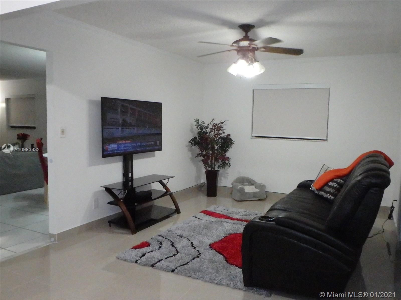 13735 Southwest 84th Street, Unit A Miami, FL 33183 - Photo 5 of 19 a living room with furniture and a chandelier