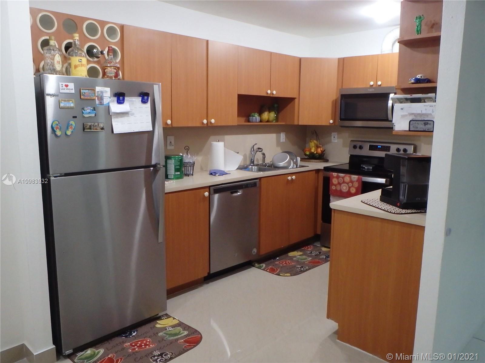 13735 Southwest 84th Street, Unit A Miami, FL 33183 - Photo 6 of 19 a white refrigerator freezer sitting in a kitchen