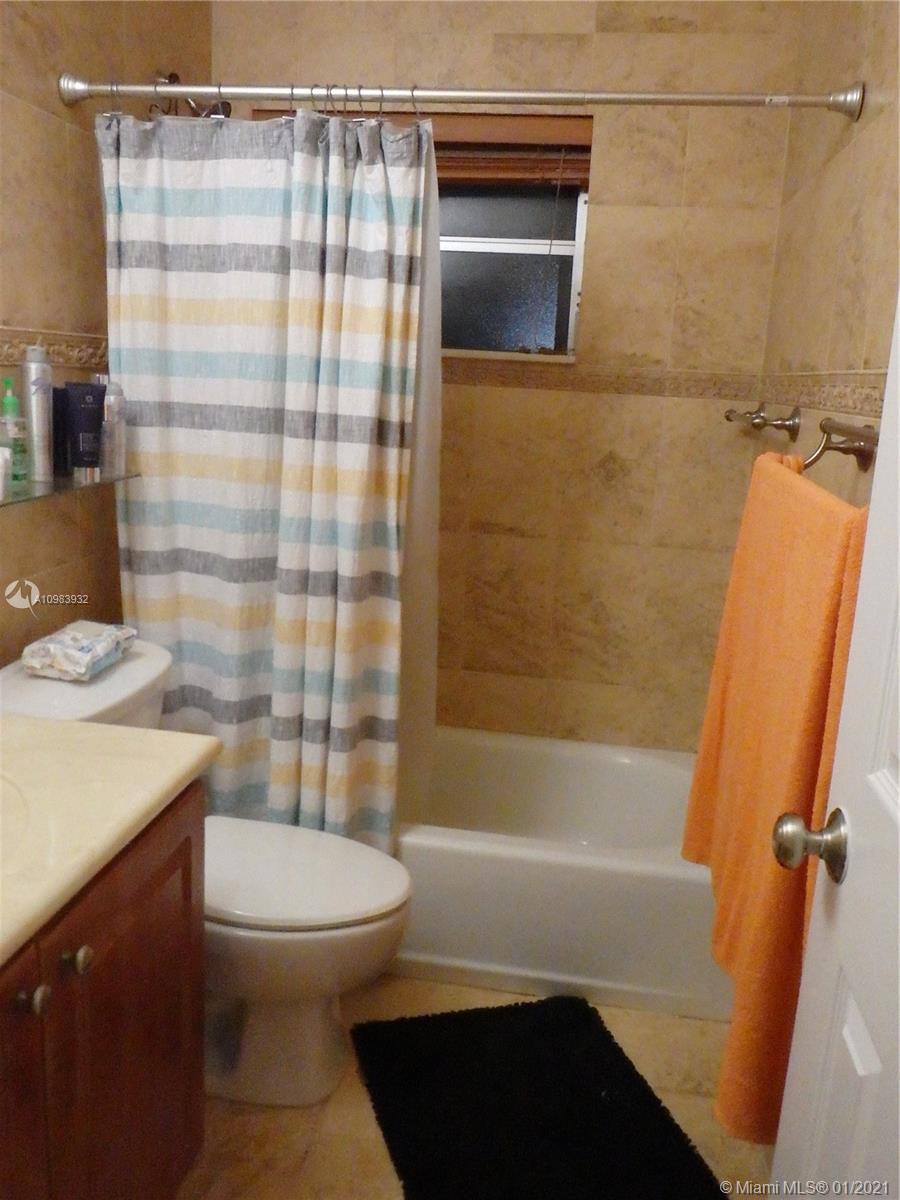 13735 Southwest 84th Street, Unit A Miami, FL 33183 - Photo 10 of 19 a bathroom with a sink a toilet and shower