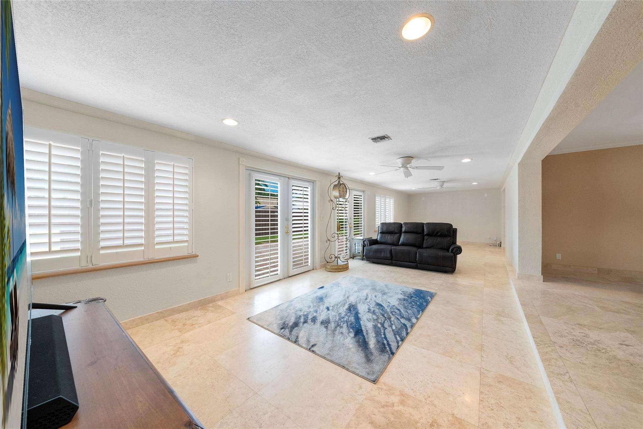 2061 North Conference Drive Boca Raton, FL 33486 - Photo 12 of 27 a living room with furniture and a flat screen tv