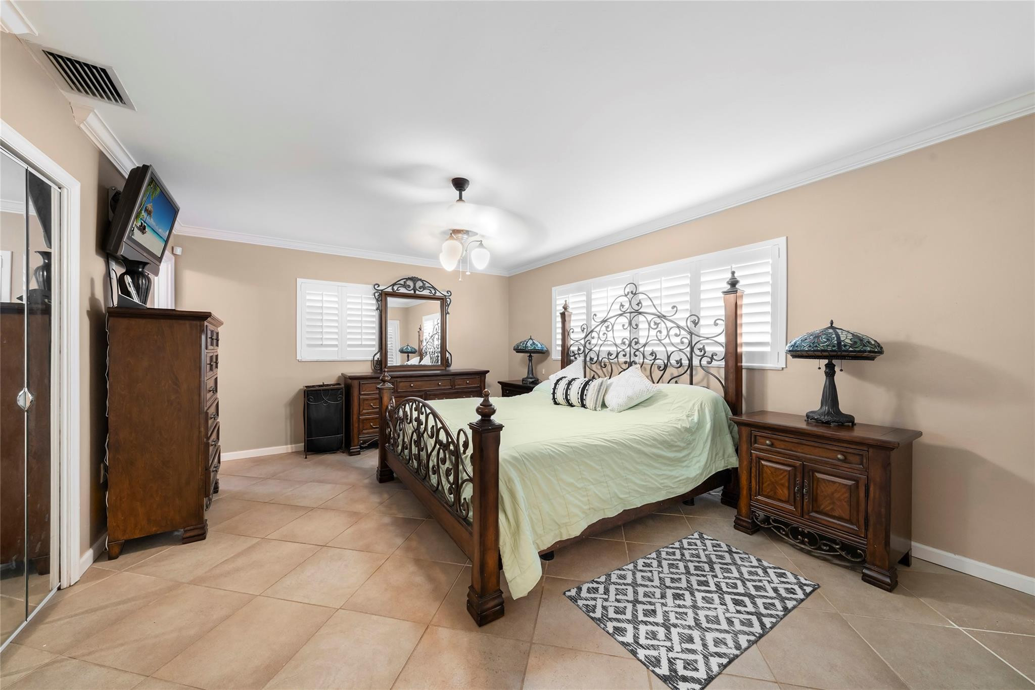 2061 North Conference Drive Boca Raton, FL 33486 - Photo 17 of 27 a bedroom with a bed and wooden floor