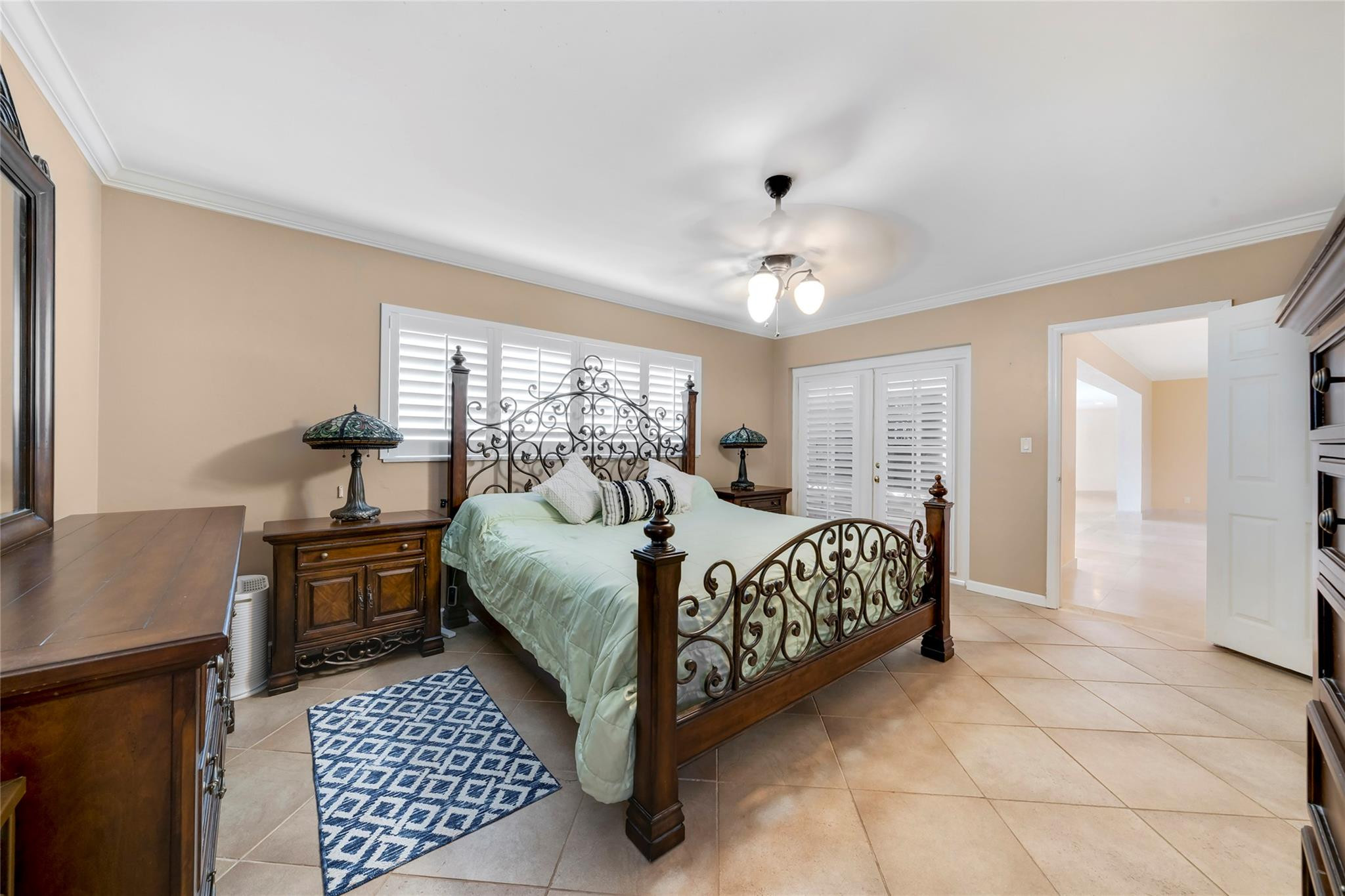 2061 North Conference Drive Boca Raton, FL 33486 - Photo 19 of 27 a bedroom with a bed and wooden floor