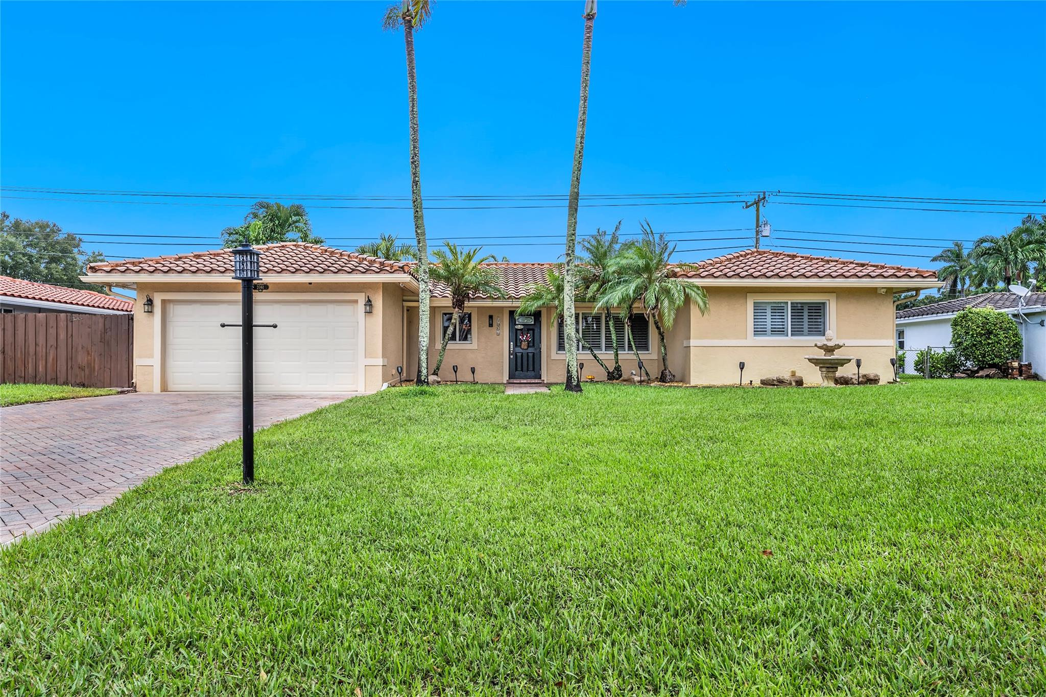 2061 North Conference Drive Boca Raton, FL 33486 - Photo 2 of 27 a front view of house with a garden