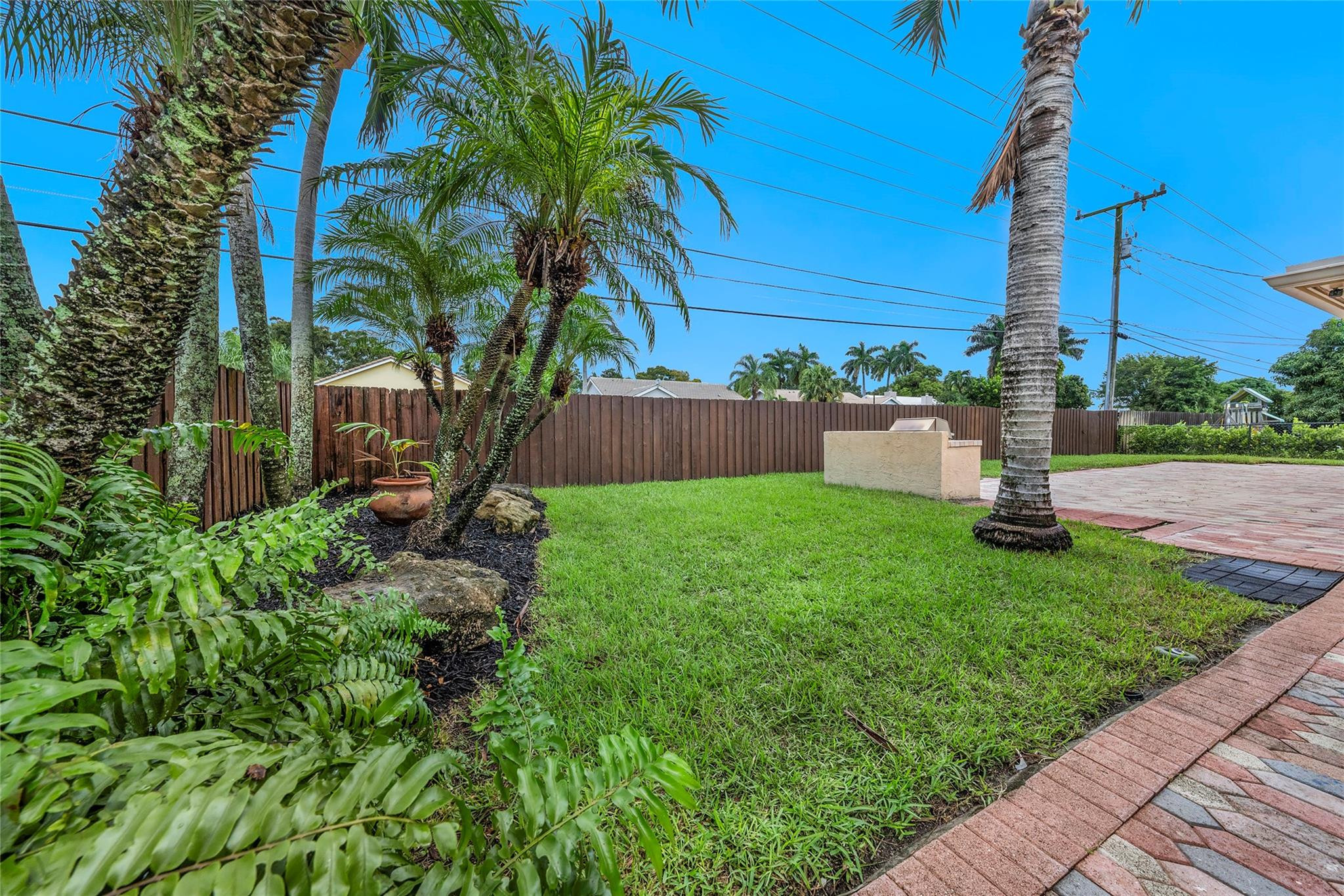 2061 North Conference Drive Boca Raton, FL 33486 - Photo 21 of 27 a front view of a house with a yard and potted plants