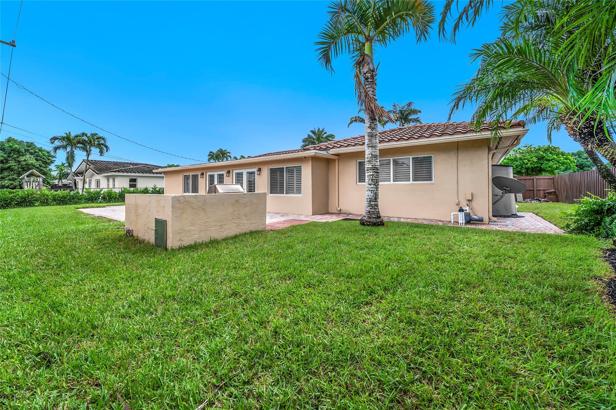 2061 North Conference Drive Boca Raton, FL 33486 - Photo 22 of 27 a view of a house with a yard and potted plants