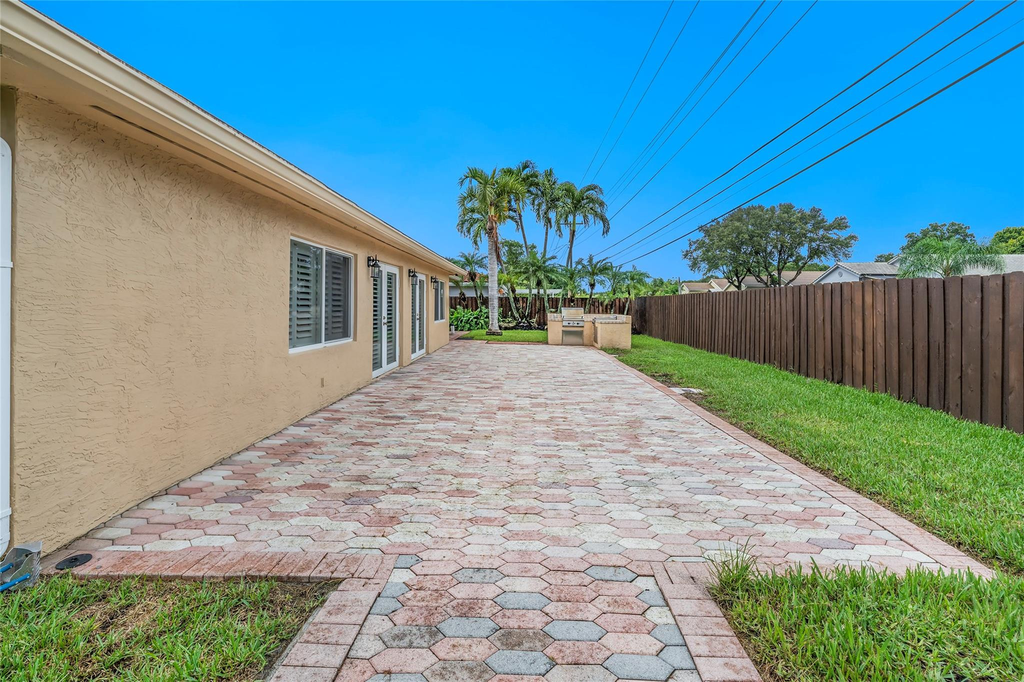 2061 North Conference Drive Boca Raton, FL 33486 - Photo 23 of 27 a view of backyard with potted plants and wooden fence