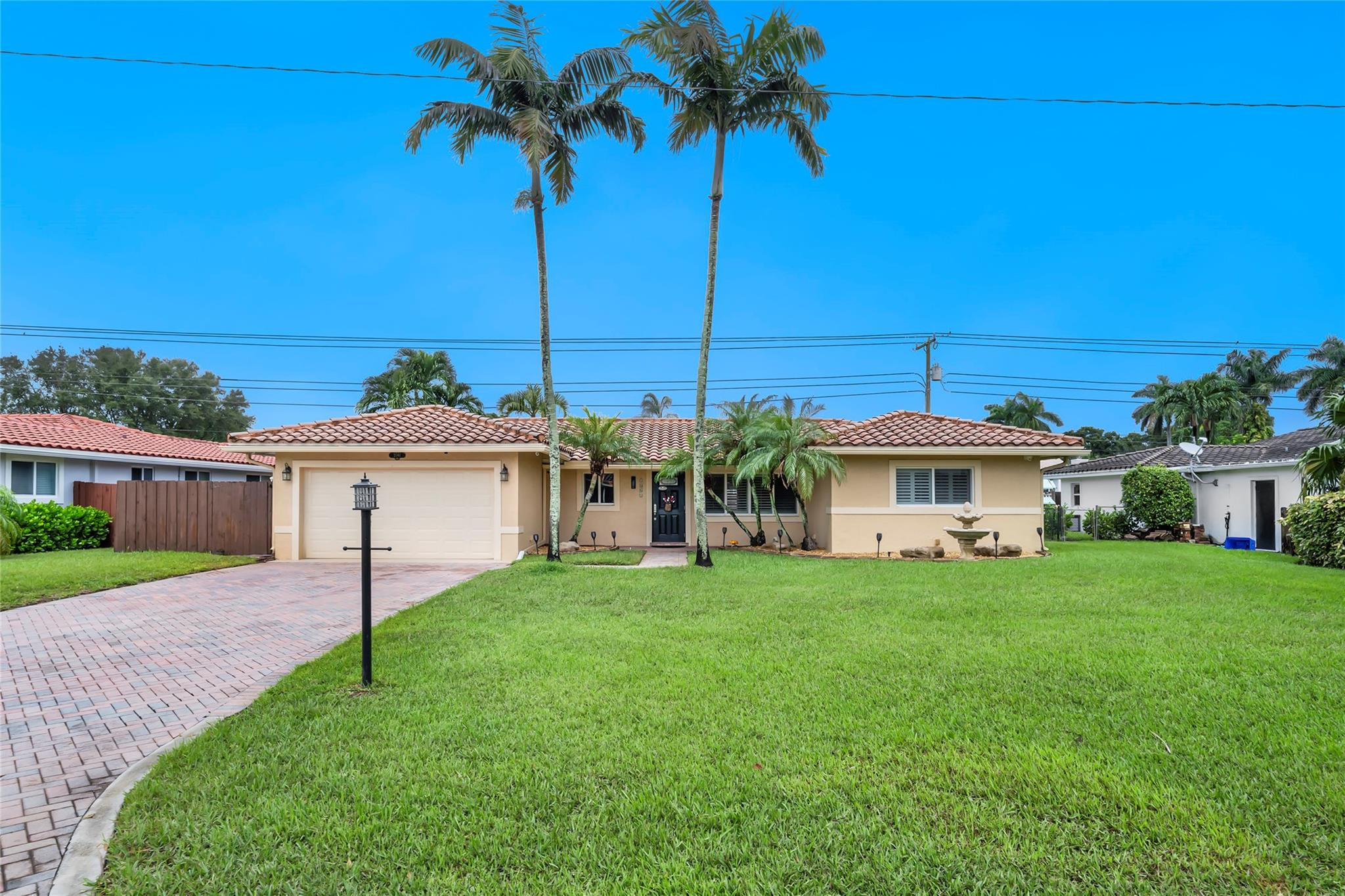 2061 North Conference Drive Boca Raton, FL 33486 - Photo 24 of 27 a view of a house with a big yard and palm trees