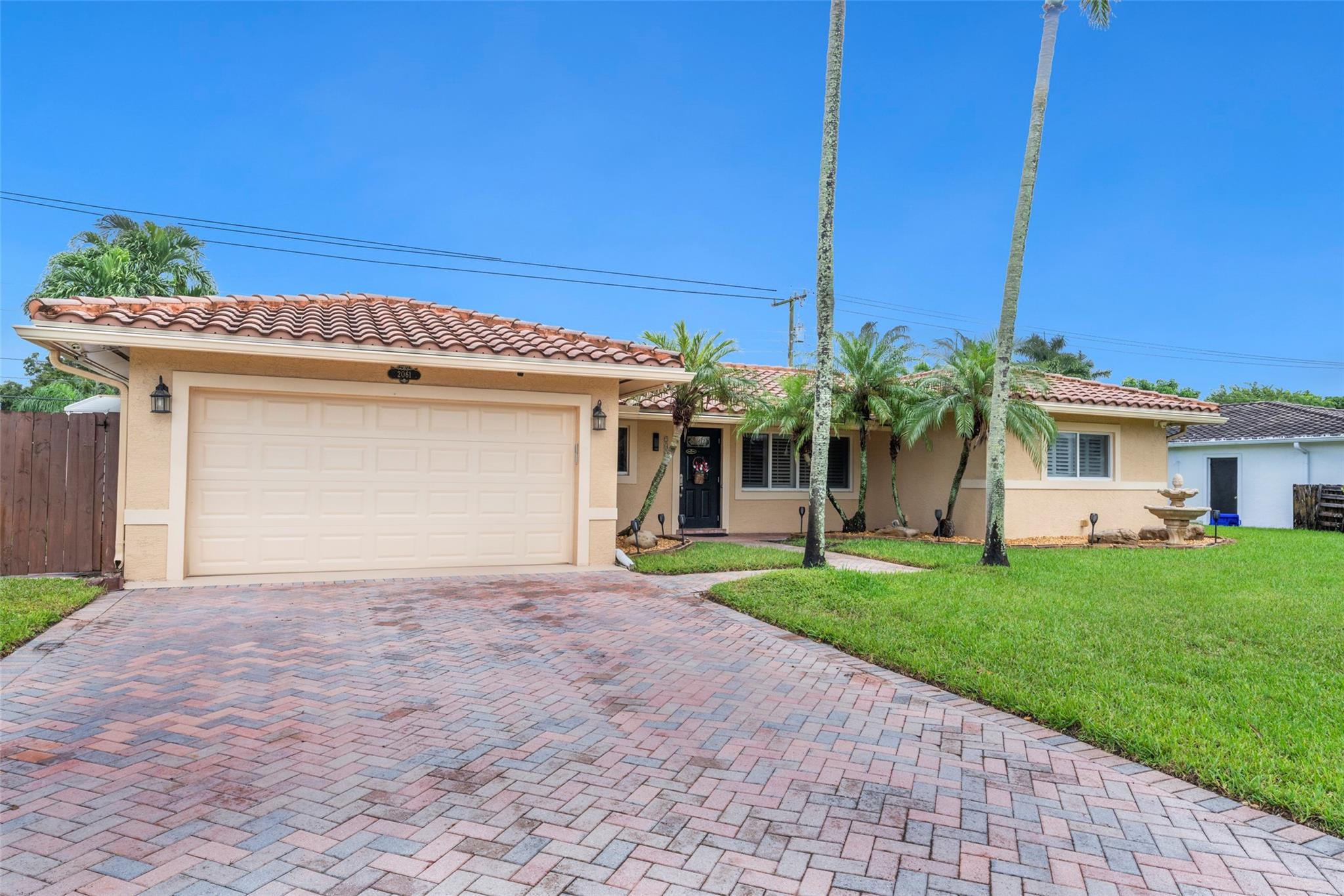 2061 North Conference Drive Boca Raton, FL 33486 - Photo 27 of 27 a front view of a house with a yard and a garage