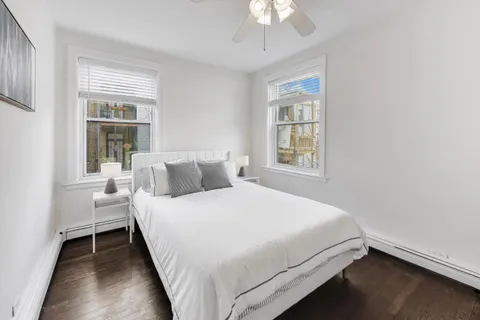 a bedroom with a bed and a window