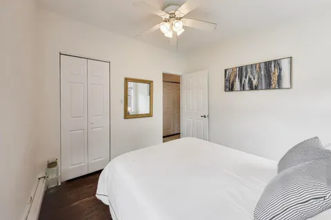 a bedroom with a large bed and a chandelier
