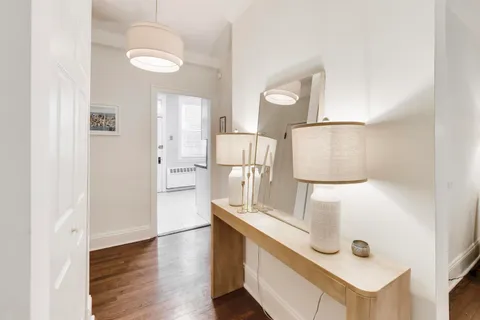 a kitchen with stainless steel appliances granite countertop a sink and a refrigerator