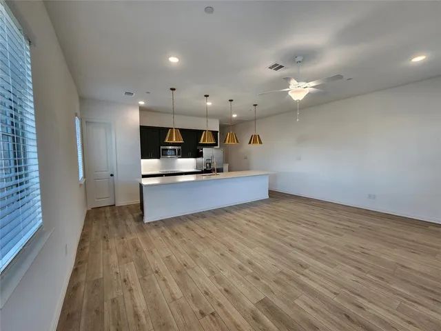 a kitchen with counter space and wooden floor