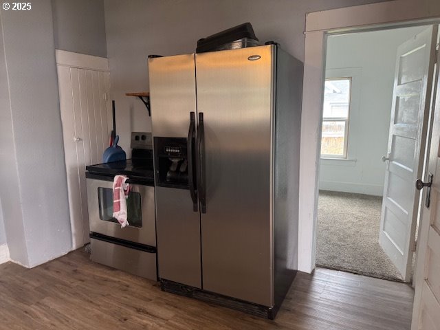 2800 10th Street Baker City, OR 97814 - Photo 12 of 23 a kitchen with metallic refrigerator and wooden floor