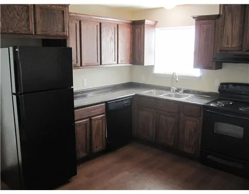 a kitchen with a sink stove and refrigerator