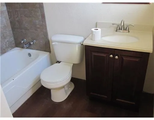 a white toilet sitting next to a bathroom sink