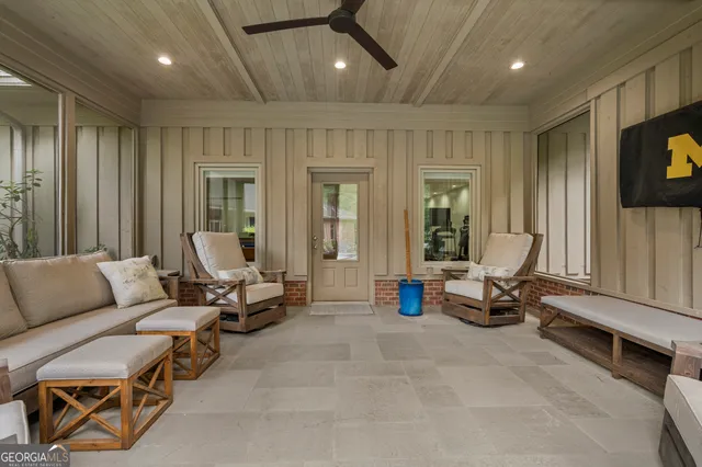 a very nice looking living room with a large window and a flat screen tv