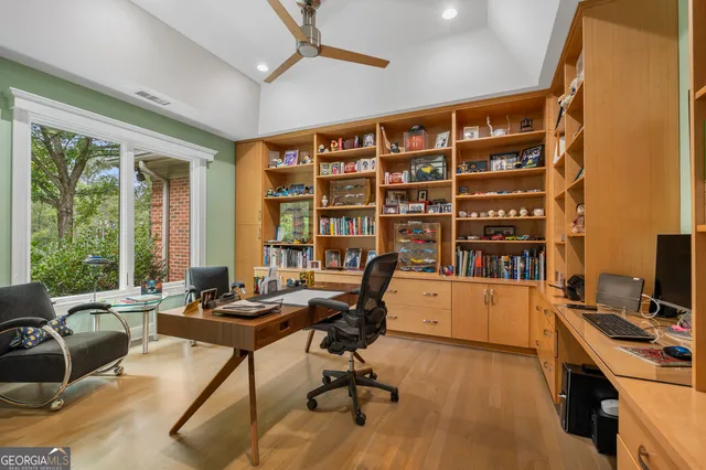 a bathroom with a granite countertop sink mirror and window