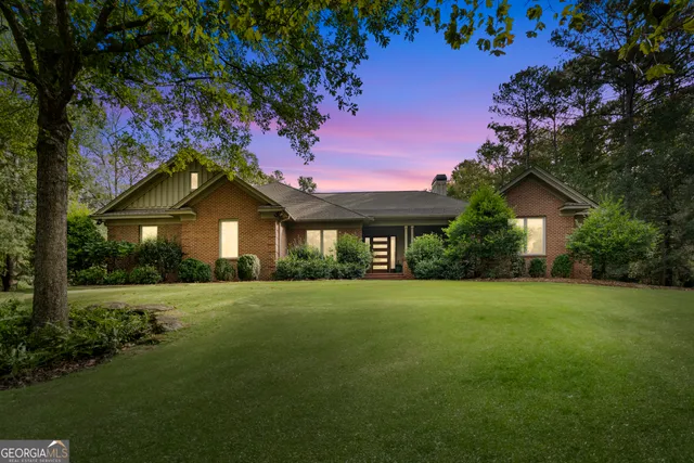 a aerial view of a house with swimming pool and sitting area