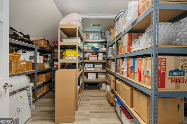 an aerial view of a house with swimming pool and outdoor seating