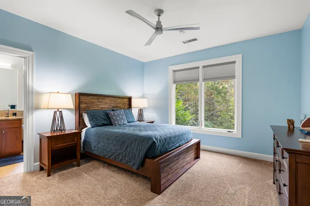 an aerial view of residential house with outdoor space and trees all around