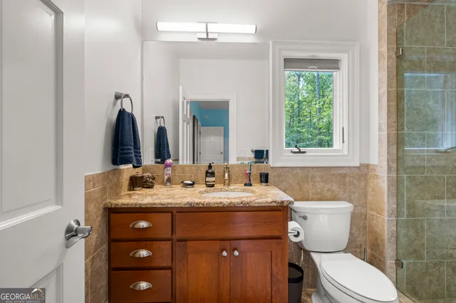 an aerial view of a house with a yard and trees
