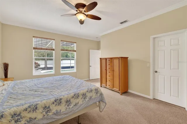 a spacious bedroom with a bed and a window