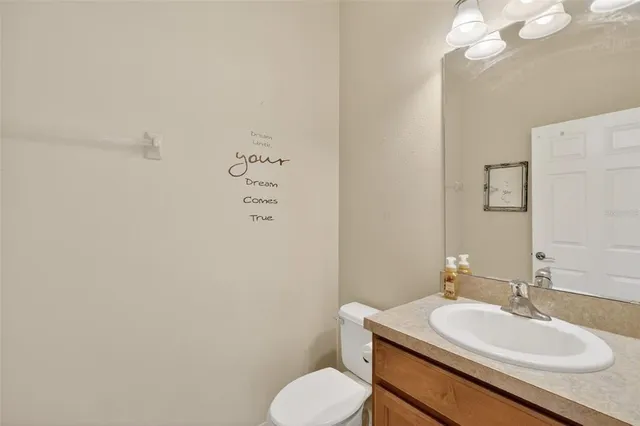 a bathroom with a sink toilet and a mirror