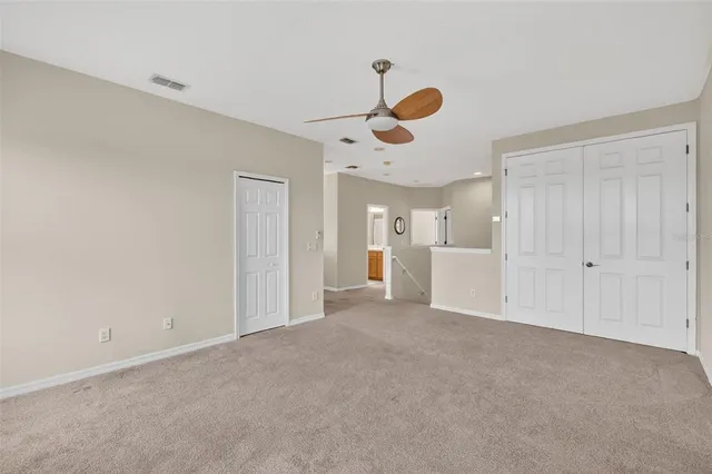 a view of a livingroom and a chandelier fan