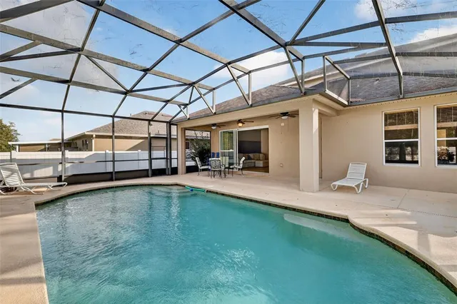 a view of a swimming pool with a patio