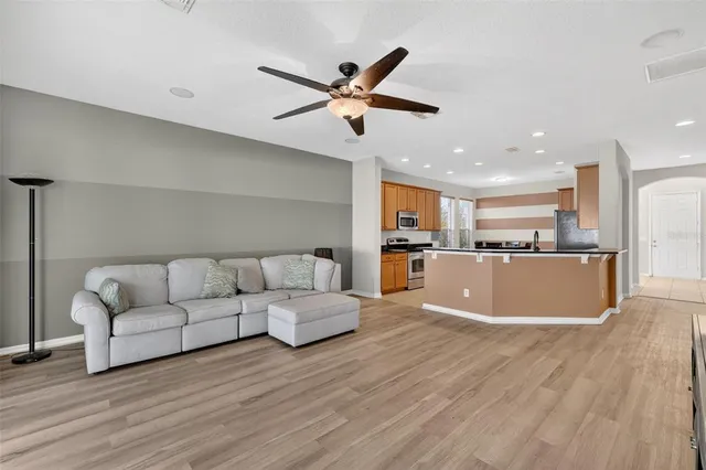 a living room with furniture and kitchen view