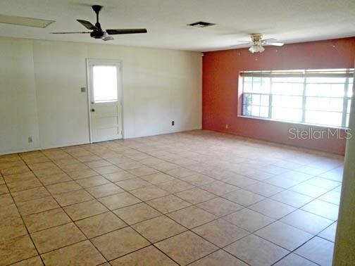 3130 Northeast 7th Lane Ocala, FL 34470 - Photo 9 of 9 an empty room with windows and fan