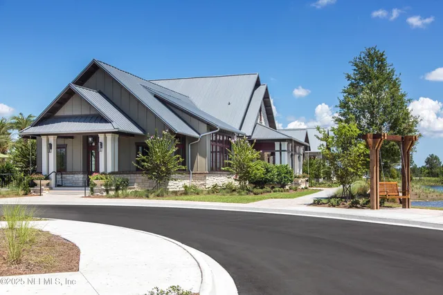 a front view of a house with yard and lake
