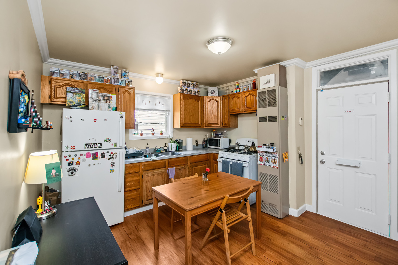 2238 West 21st Place Chicago, IL 60608 - Photo 21 of 37 a kitchen with a refrigerator a stove and wooden floor